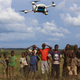 A group in Lilongwe watches a UNICEF drone designed to deliver HIV tests to hospitals.